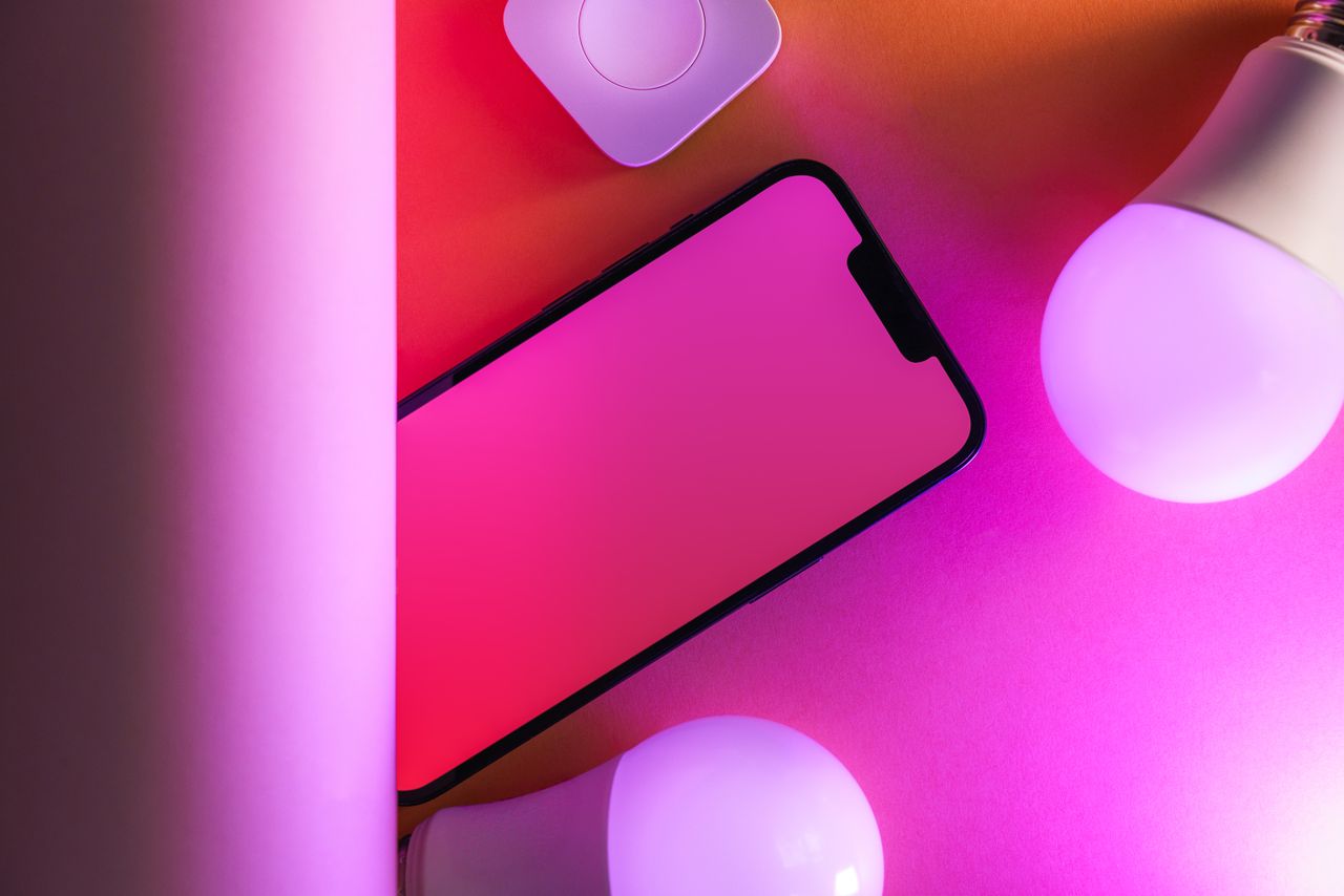 get-in-touch Colorful tech arrangement with smartphone and smart bulbs, perfect for modern design concepts.