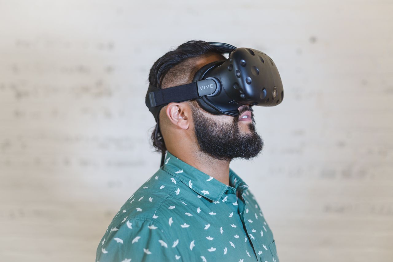 services-06 Adult male using a virtual reality headset for immersive experience indoors.
